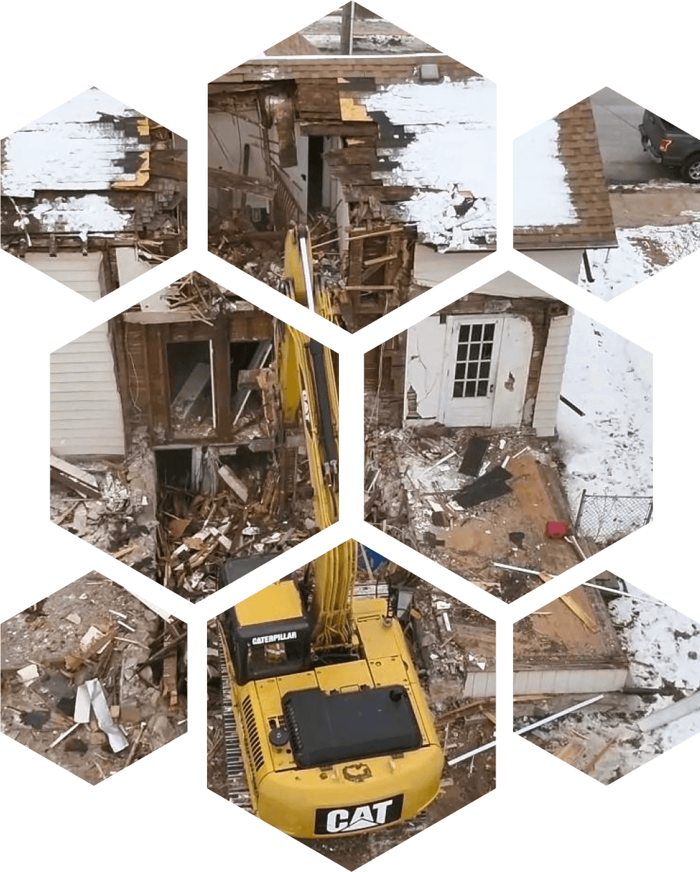 An excavator tearing down an old house, clearing debris for site preparation.